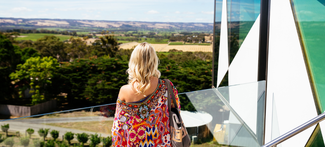 Back shot of woman looking at vineyard